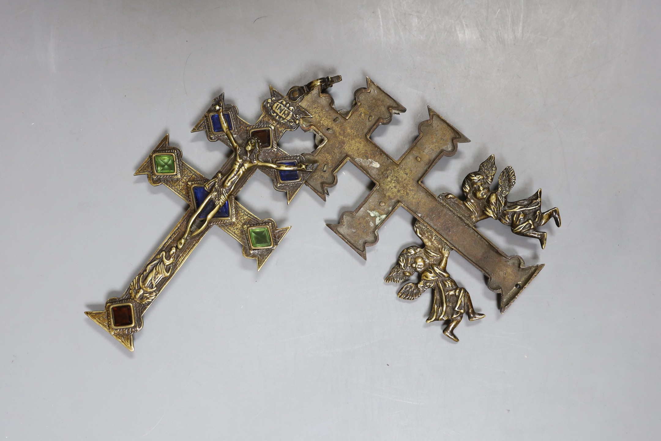 A brass stained glass crucifix inscribed ‘INRI’ with swivel movement - 18cm high